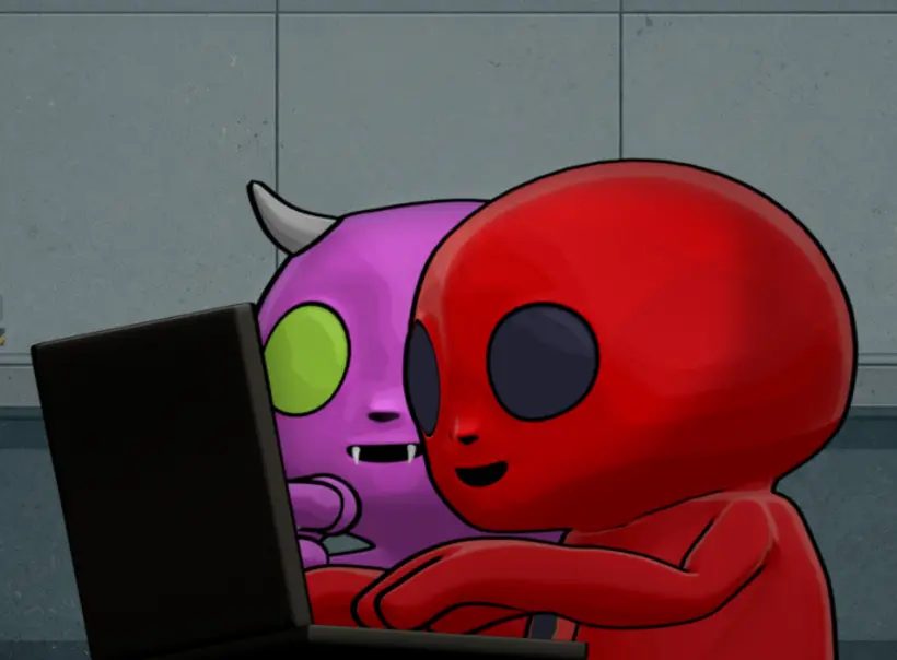 Two players huddled around a laptop in-game